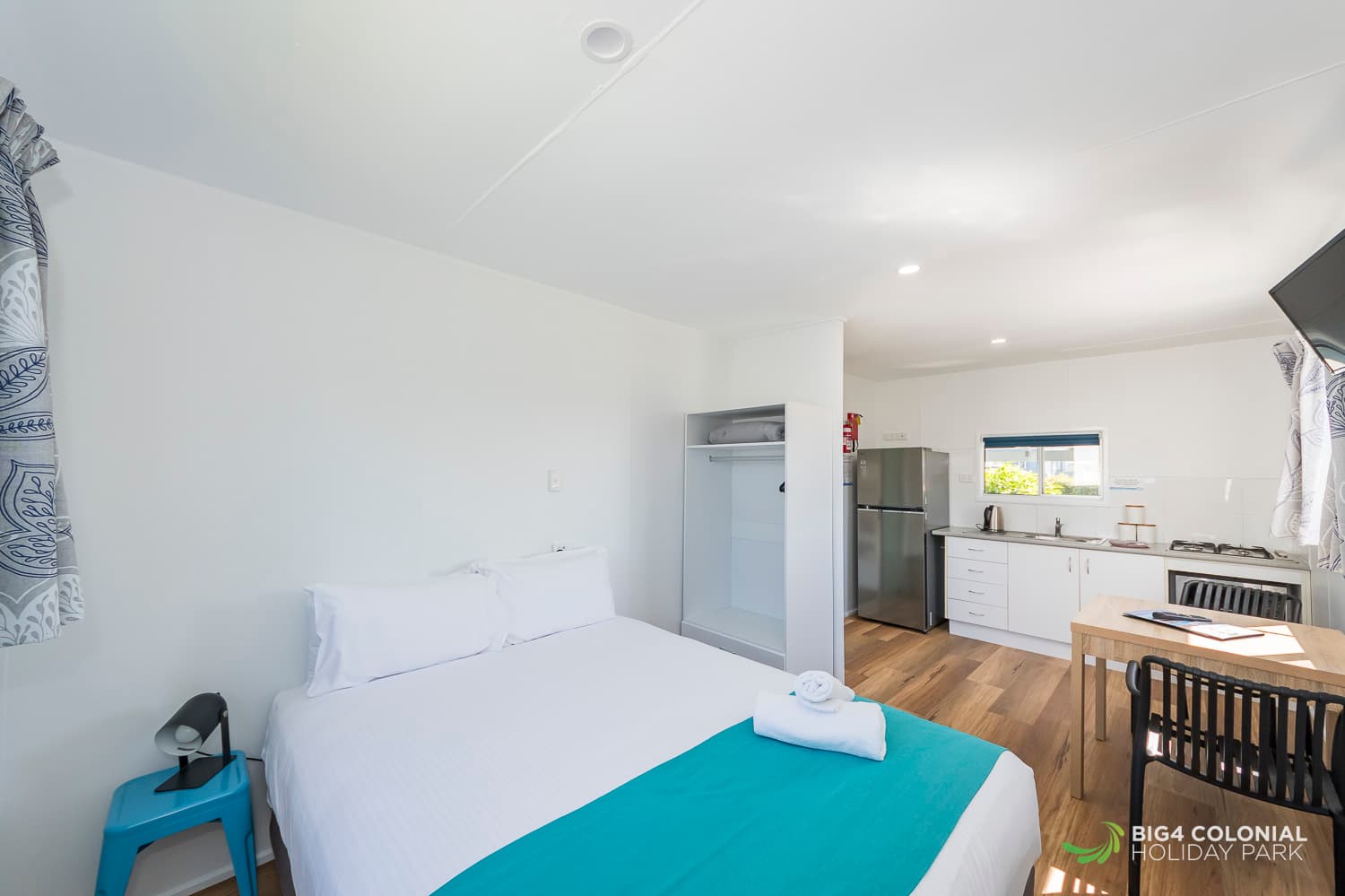 Queen bed and kitchenette in Two Room Studio cabins. 