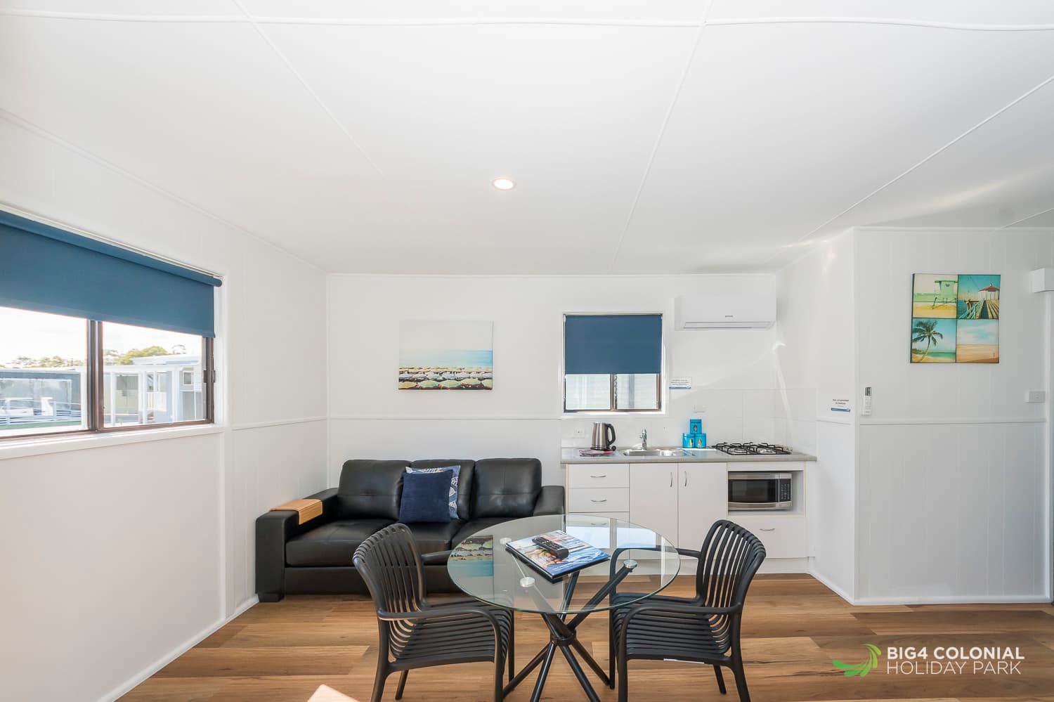 Three seater couch, kitchenette and dining table to studio cabins. 