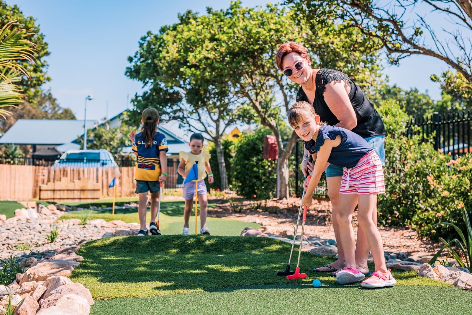 family playing mini golf